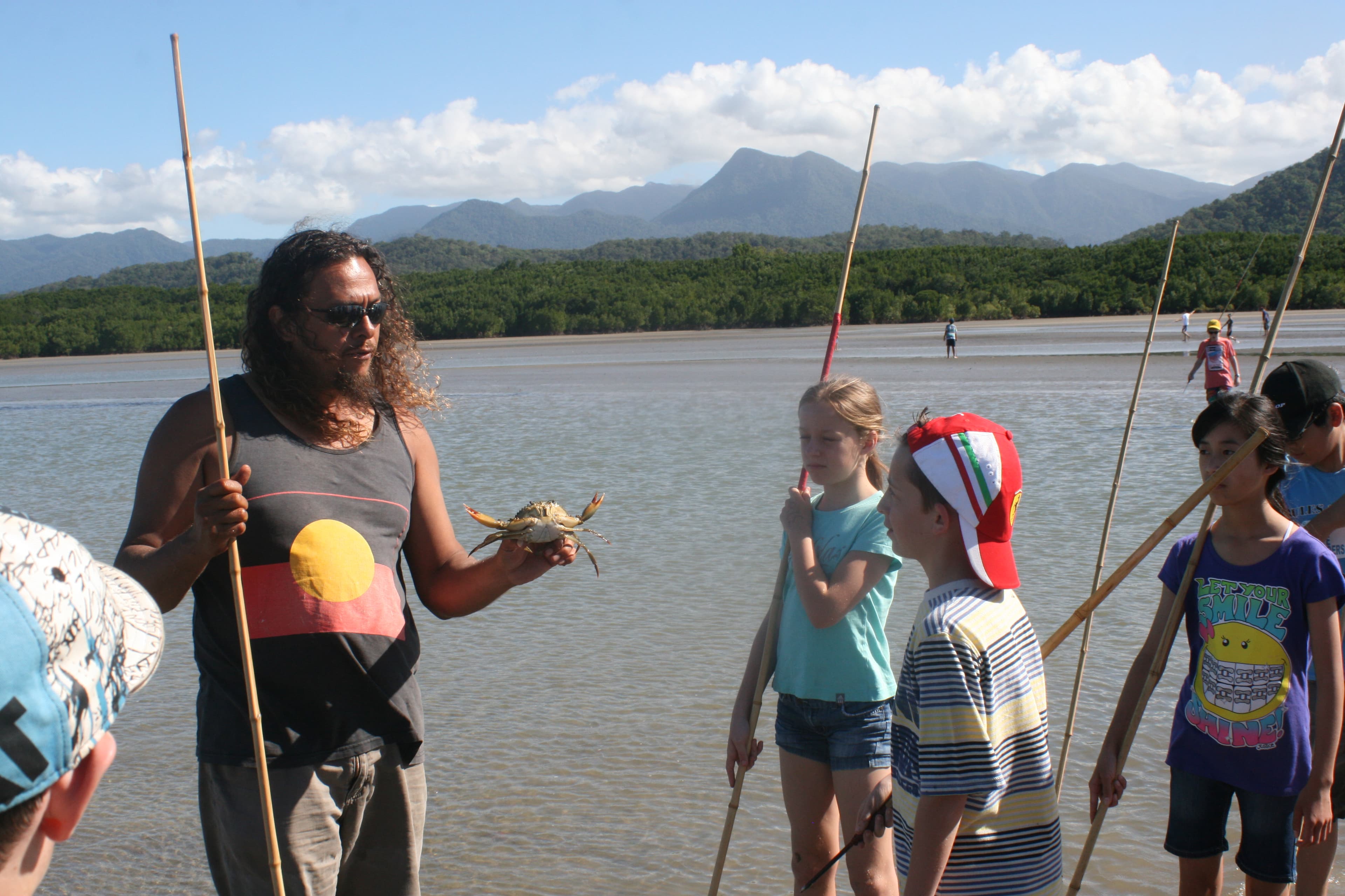 An indiginous guide showing hunting techniques to a Small World Journeys group